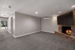 Cozy up by the brick fireplace in this inviting living space, complete with a large flat-screen TV for entertainment.