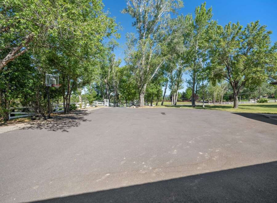 Enjoy outdoor recreation on this expansive paved area, perfect for basketball or other activities.