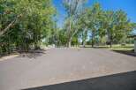 Enjoy outdoor recreation on this expansive paved area, perfect for basketball or other activities.