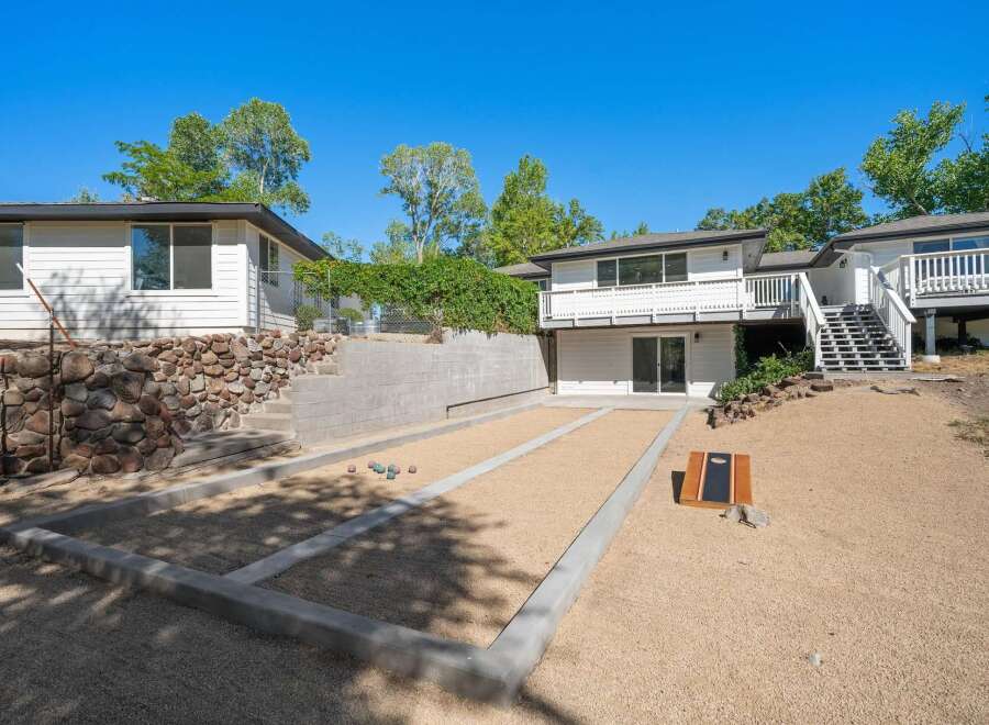 Enjoy outdoor recreation with a dedicated bocce ball court and a cornhole set, perfect for entertaining guests.