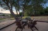 Gather around the fire pit in this inviting outdoor seating area, perfect for enjoying cool evenings under the stars.
