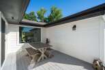 Enjoy outdoor living on this charming deck, complete with a rustic picnic table and benches perfect for al fresco dining.