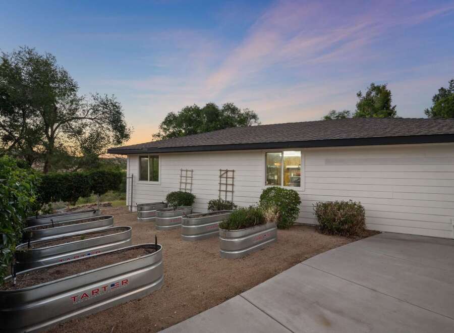 Discover a gardener's paradise with multiple raised garden beds, perfect for cultivating your own produce.