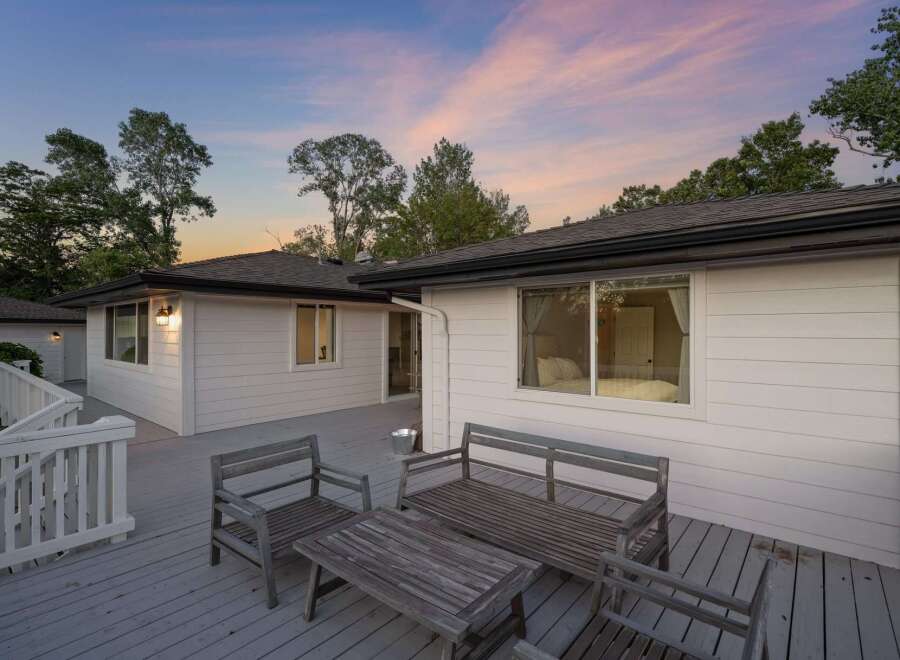 Enjoy tranquil evenings on this expansive deck, perfect for entertaining or relaxing amidst a serene natural setting.