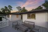 Enjoy tranquil evenings on this expansive deck, perfect for entertaining or relaxing amidst a serene natural setting.