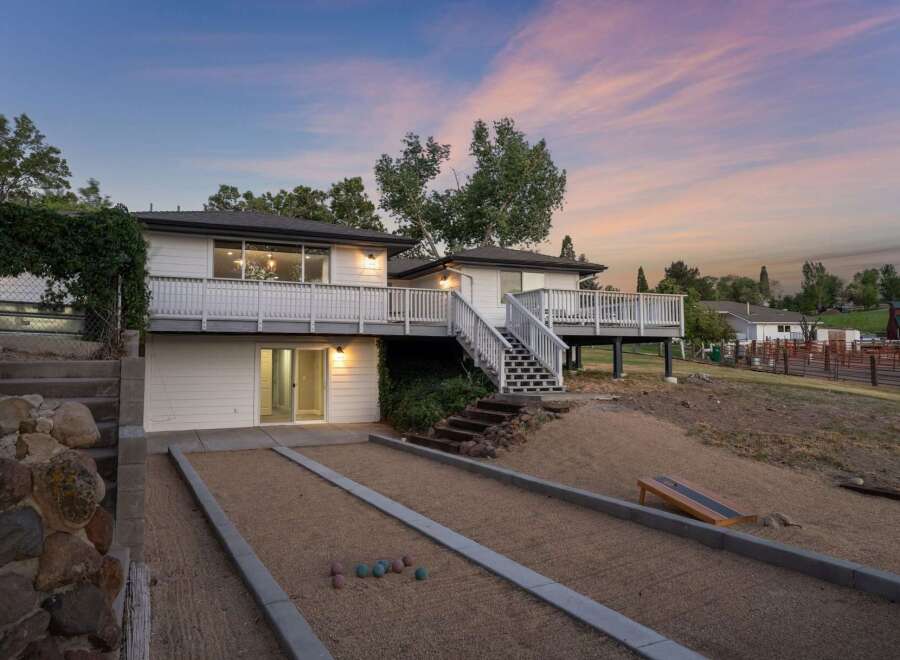 Enjoy outdoor recreation with a bocce ball court and cornhole set, perfect for gatherings.
