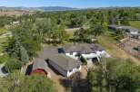 Discover this expansive property featuring a spacious main residence and a charming red barn, perfect for equestrian enthusiasts.