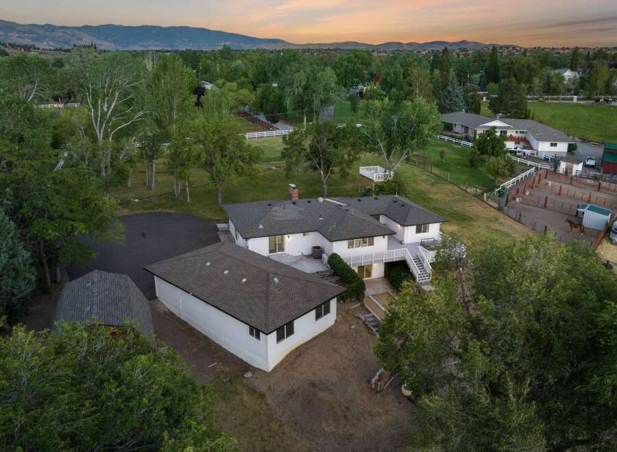 Discover this expansive property featuring a spacious main house with a large deck and a separate garage.