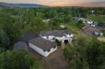 Discover this expansive property featuring a spacious main house with a large deck and a separate garage.