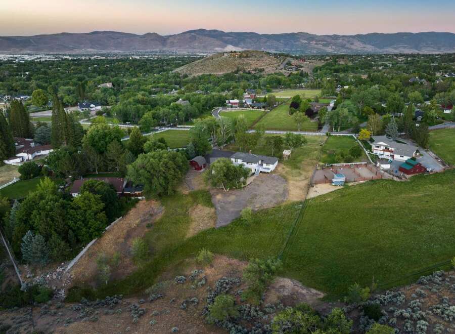 Discover this expansive property featuring a spacious home with multiple outbuildings, perfect for equestrian enthusiasts or those seeking ample storage.