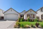 Charming single-family home featuring a well-maintained lawn and vibrant landscaping.