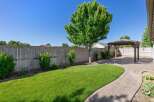 Enjoy outdoor living in this beautifully landscaped backyard featuring a spacious paver patio and a charming wooden gazebo, perfect for entertaining or relaxing.