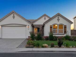 Discover this charming single-story home featuring a stucco exterior and a welcoming facade.