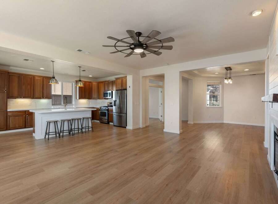 Experience modern living in this spacious open-concept home featuring a gourmet kitchen with rich wood cabinetry and a large island perfect for entertaining.