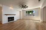 Experience modern living in this beautifully appointed living room, featuring a striking white shiplap fireplace with a rustic wood mantel.