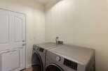 Discover a functional laundry room featuring a modern Samsung washer and dryer set, perfect for handling your household needs.