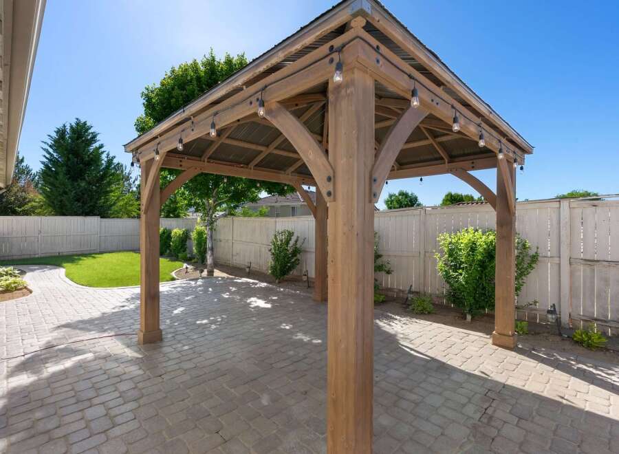 Enhance your outdoor living space with this stunning wooden gazebo, perfect for entertaining or relaxing.