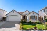 Discover this charming single-story home featuring a welcoming facade with stone accents and a well-maintained lawn.