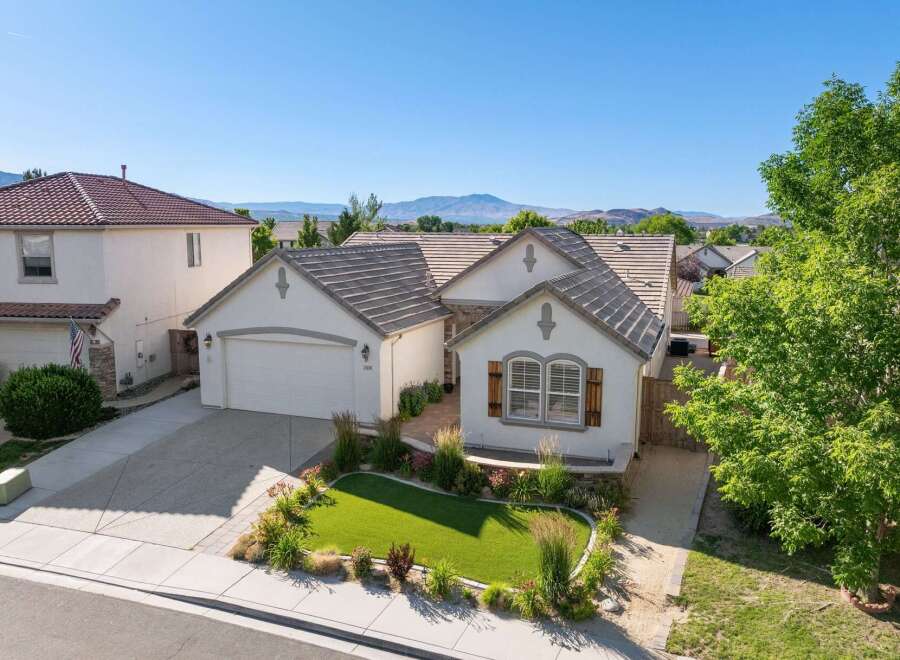 Discover this charming single-story home featuring a beautifully manicured front lawn and a welcoming entryway.