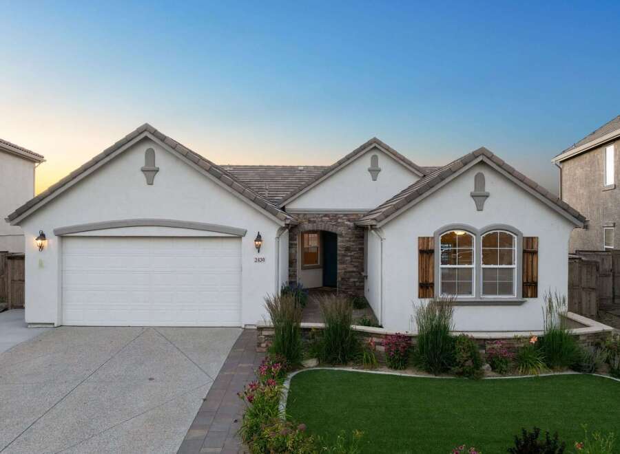 Charming single-family home featuring a stucco exterior and a tile roof.
