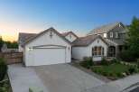 Discover this charming home featuring a spacious driveway leading to a two-car garage.