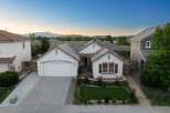 Discover this charming single-family home featuring a welcoming facade with a well-maintained lawn and mature landscaping.