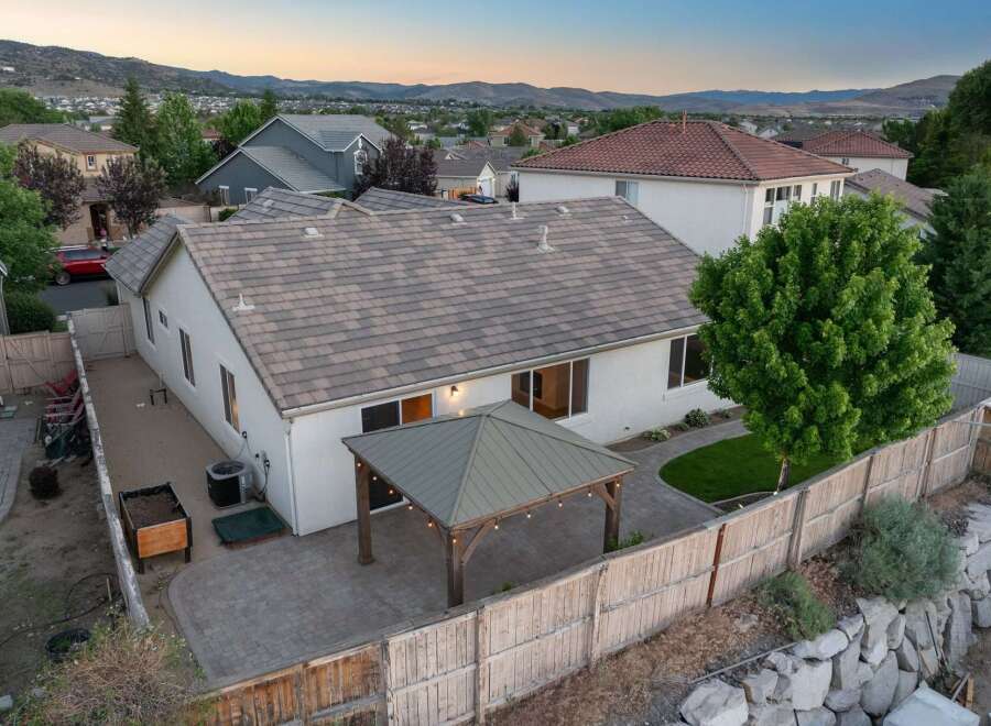 Enjoy outdoor living with this spacious backyard featuring a covered patio perfect for entertaining.