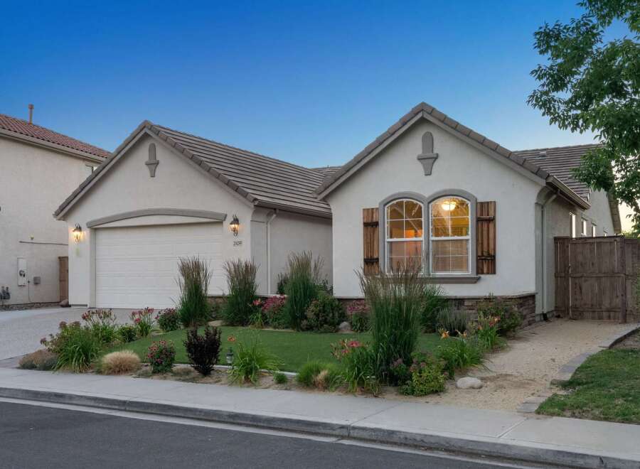 Charming single-story home featuring a stucco exterior and a tile roof.