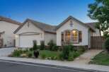 Charming single-story home featuring a stucco exterior and a tile roof.