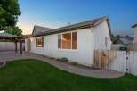 Enjoy outdoor living in this charming backyard featuring a covered patio with string lights, perfect for entertaining.