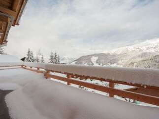 Experience the ultimate winter wonderland from this stunning property's balcony, offering breathtaking panoramic views of snow-capped mountains.