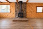 Cozy up by the rustic stone fireplace, a stunning focal point in this inviting living space.