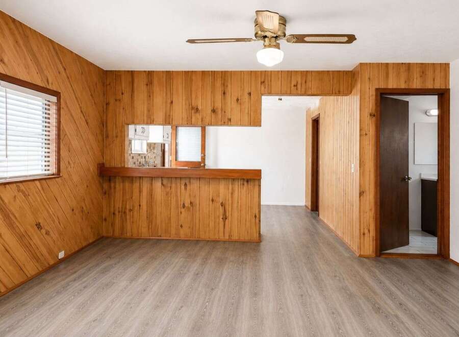 Step into this charming space featuring warm wood paneling throughout, creating a cozy and inviting atmosphere.