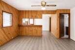 Step into this charming space featuring warm wood paneling throughout, creating a cozy and inviting atmosphere.