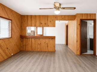 Step into this charming space featuring warm wood paneling throughout, creating a cozy and inviting atmosphere.