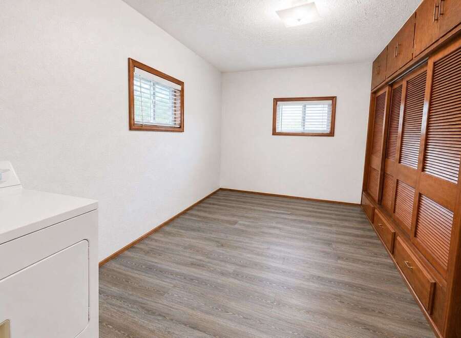 Discover this charming room featuring a convenient in-unit washer and dryer, perfect for modern living.