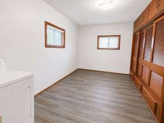 Discover this charming room featuring a convenient in-unit washer and dryer, perfect for modern living.
