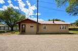 Discover this charming single-story home featuring a durable metal roof and a welcoming tan stucco exterior.