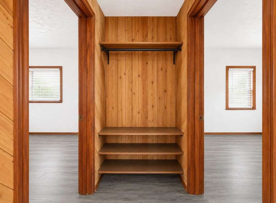 Discover ample storage solutions in this charming home, featuring a built-in closet with a hanging rod and three spacious shelves.