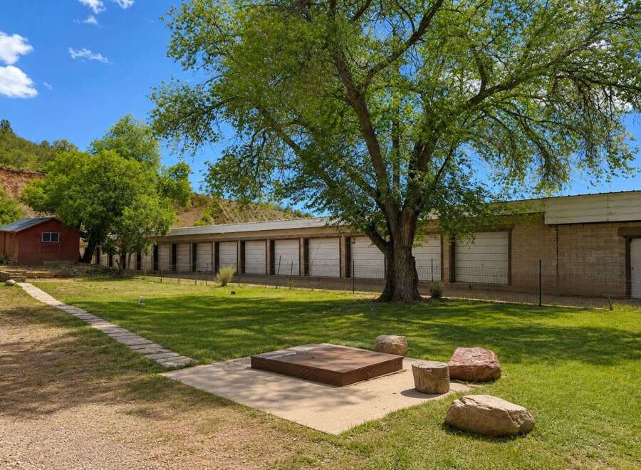 Discover this unique property featuring a long row of storage units, perfect for a business or personal storage needs.
