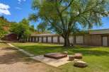 Discover this unique property featuring a long row of storage units, perfect for a business or personal storage needs.