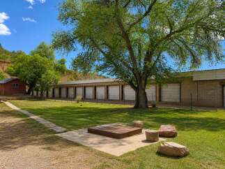 Discover this unique property featuring a long row of storage units, perfect for a business or personal storage needs.