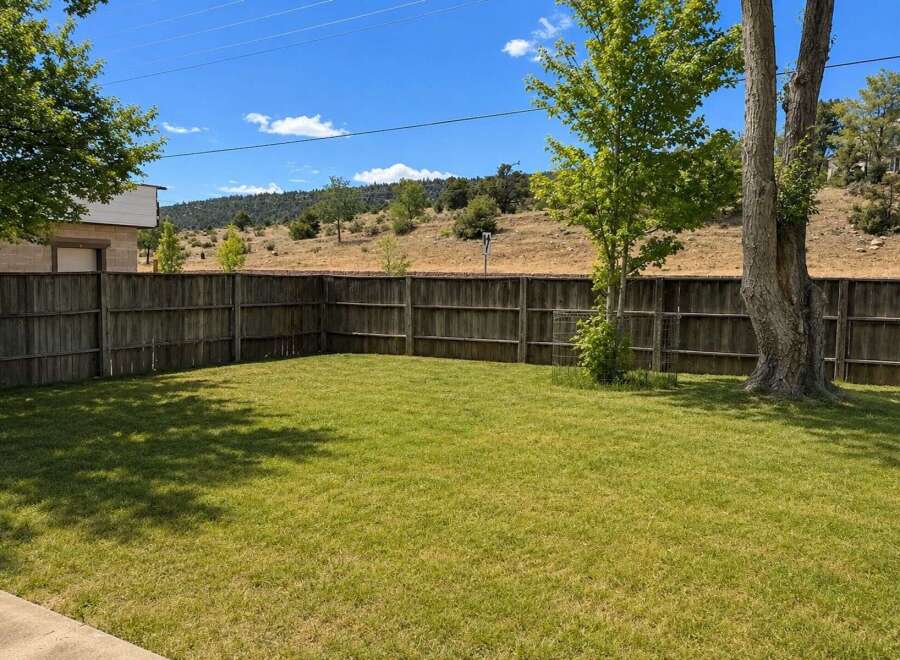 Enjoy the spacious backyard with a well-maintained lawn, perfect for outdoor activities and relaxation.