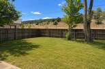 Enjoy the spacious backyard with a well-maintained lawn, perfect for outdoor activities and relaxation.