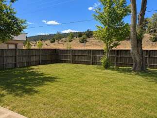 Enjoy the spacious backyard with a well-maintained lawn, perfect for outdoor activities and relaxation.
