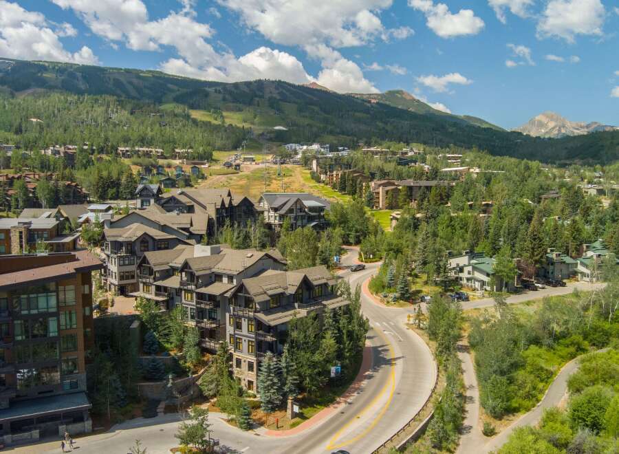 Discover this stunning mountain resort community, featuring modern architecture nestled amidst lush greenery and scenic mountain vistas.
