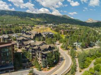 Discover this stunning mountain resort community, featuring modern architecture nestled amidst lush greenery and scenic mountain vistas.