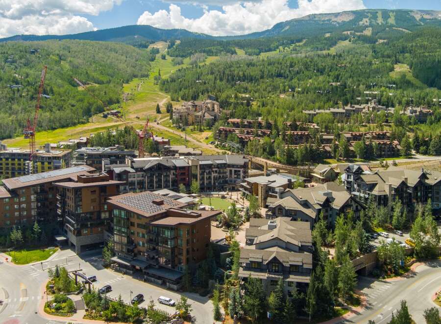 Experience luxury mountain living in this stunning development, featuring modern architecture and sustainable design with solar panels.