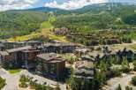 Experience luxury mountain living in this stunning development, featuring modern architecture and sustainable design with solar panels.