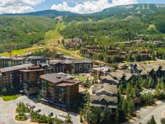 Experience luxury mountain living in this stunning development, featuring modern architecture and sustainable design with solar panels.